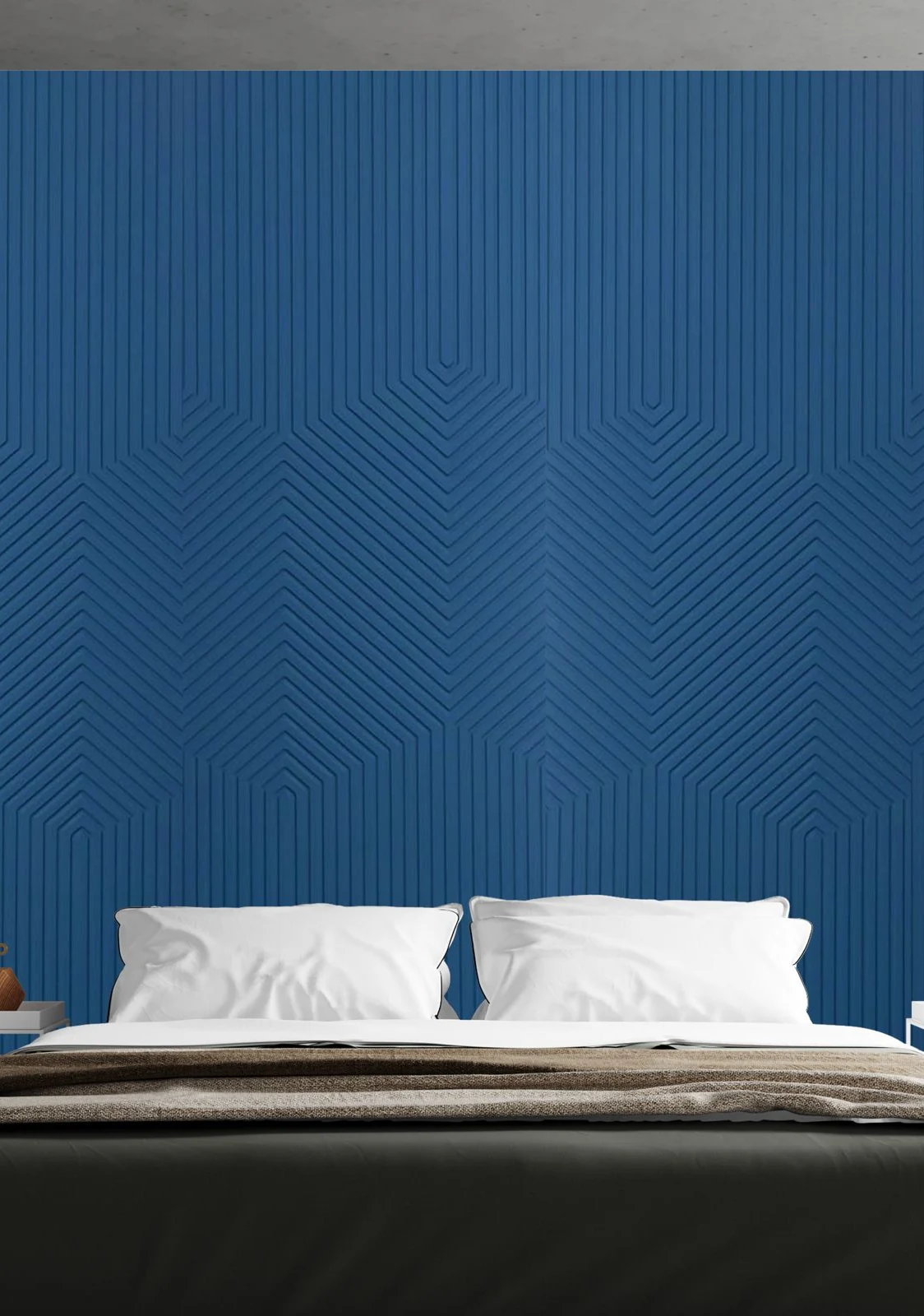 Deep blue chevron-relief Vectra panel wall behind a low bed