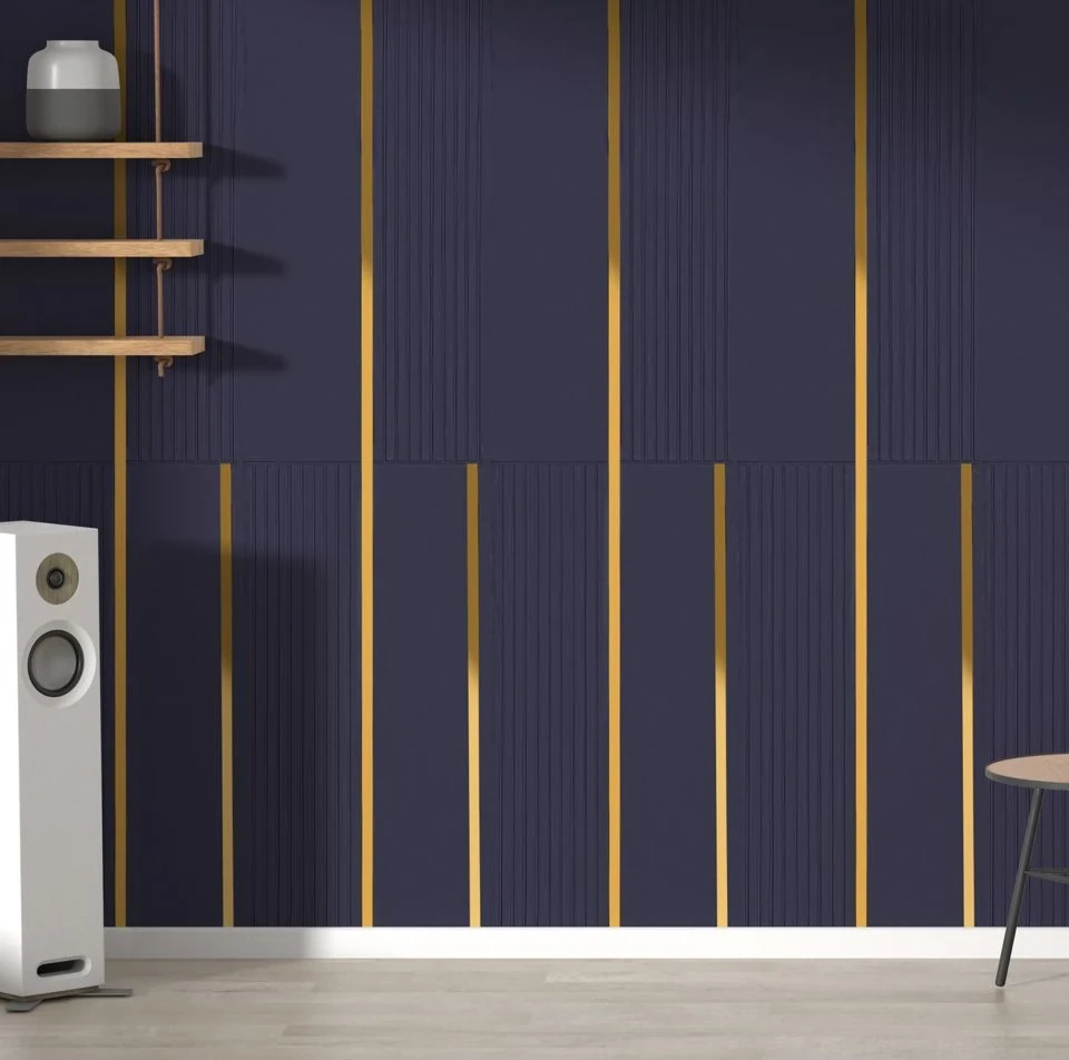 Navy fluted panelling with slim brass inlays running floor to ceiling behind a speaker and shelf