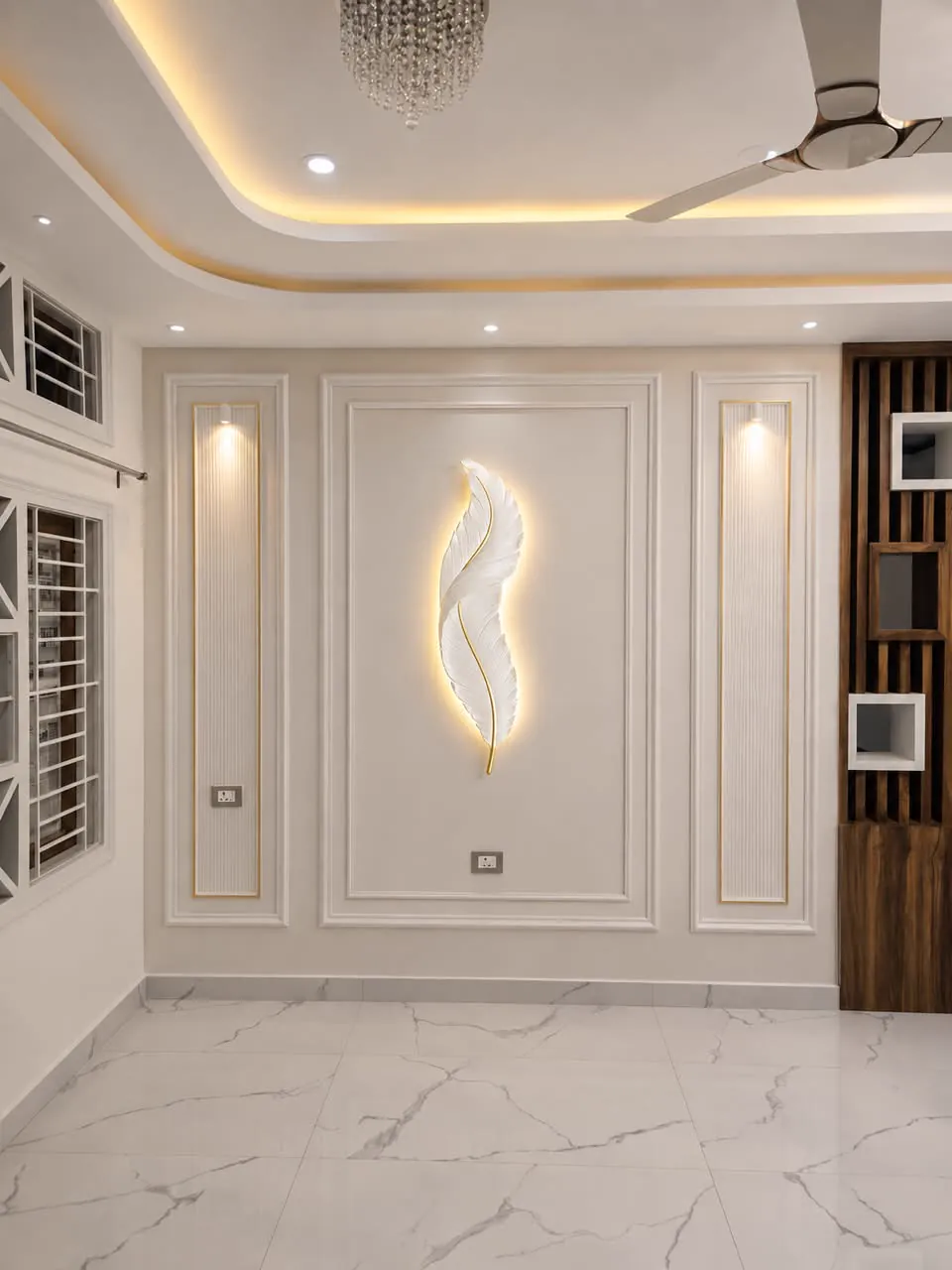 Cream wall with PU panel mouldings, a white feather wall light in the centre panel and two fluted side panels